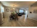 Open-concept living and dining area with wood floors, modern lighting, and stylish decor at 133 15Th Nw St, Largo, FL 33770