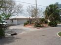Charming single-story home with a two-car garage and well-maintained landscaping at 1844 Venetian Point Dr, Clearwater, FL 33755