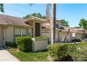 Well-kept home with a 2-car garage, complemented by mature trees and vibrant bushes, adding natural beauty at 3056 Pepperwood W Ln, Clearwater, FL 33761