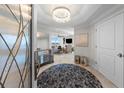 Foyer with chandelier, mirrored console, round rug, and view of water from living room at 3435 Bayshore Blvd # 1401S, Tampa, FL 33629