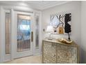 Elegant foyer featuring custom glass door, travertine flooring, and stylish accents; ideal for making a lasting first impression at 3435 Bayshore Blvd # 1401S, Tampa, FL 33629