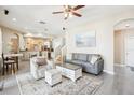 Open-concept living room showcasing modern decor, neutral tones, and an adjacent dining area at 3503 Williston Loop, Land O Lakes, FL 34639