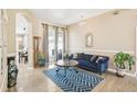 Comfortable living room with a blue velvet couch and a stylish rug at 3503 Williston Loop, Land O Lakes, FL 34639