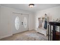Inviting entryway with decorative double doors, a coat rack, and a stylish area rug at 378 Tennessee Ave, Crystal Beach, FL 34681