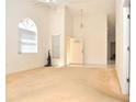 Inviting living room with vaulted ceiling and large arched window, offering abundant natural light and a welcoming atmosphere at 3876 Darston St, Palm Harbor, FL 34685