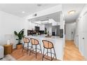 Modern kitchen with white cabinets, stainless steel appliances, and sleek bar seating at 408 S Arrawana Ave # B4, Tampa, FL 33609