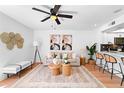 Cozy living area with contemporary artwork, comfortable seating, and a view of the kitchen bar at 408 S Arrawana Ave # B4, Tampa, FL 33609