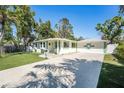 Inviting single-story home with a spacious driveway, lush lawn, and delightful garden accent at 4846 Highland S St, St Petersburg, FL 33705