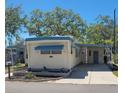 Inviting mobile home with covered parking and landscaped entrance, offering a cozy curb appeal at 585 Sky Harbor Dr # 120, Clearwater, FL 33759