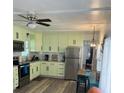 Bright eat-in kitchen with stainless steel appliances, modern cabinets, and hardwood flooring at 585 Sky Harbor Dr # 120, Clearwater, FL 33759