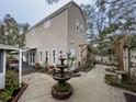 A backyard shows a patio and garden area, with a fountain as its focal point at 6166 9Th N Ave, St Petersburg, FL 33710