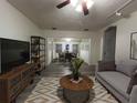 Spacious living room featuring stylish furnishings and wood-look flooring that extends to the adjacent dining area at 6166 9Th N Ave, St Petersburg, FL 33710