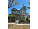 Attractive two-story home with a metal roof, mature landscaping, and a welcoming front porch at 625 Mirabay Blvd, Apollo Beach, FL 33572