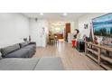 An open-concept living area leads into the kitchen and features wood-look floors at 7210 N Manhattan Ave # 1721, Tampa, FL 33614