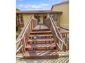 Exterior shot of a two-story building with wood stairs and railings, leading to the entrance at 7741 Forest Trl # 7, Port Richey, FL 34668
