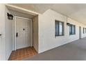 Neutral colored unit front door with sidelight window and overhead lighting at 8150 Brent St # 725, Port Richey, FL 34668