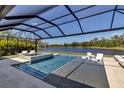 Stunning pool area with a relaxing spa and scenic lake views, perfect for outdoor enjoyment at 9133 Warm Springs Cir, Parrish, FL 34219