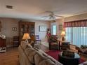 Cozy living room with comfortable seating, a decorative cabinet, and natural light at 9208 37Th N St, Pinellas Park, FL 33782