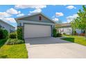 Attractive home featuring a two-car garage, stone accents, and neatly trimmed landscaping at 11221 Gold Compass St, Gibsonton, FL 33534