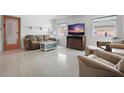 Comfortable living room with a couch, chairs, a TV, and neutral tones, ideal for relaxation and entertainment at 121 46Th Ave # 2H, St Pete Beach, FL 33706