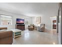 Cozy living room with comfortable furnishings, a TV, and a view of the exterior, creating a welcoming space at 121 46Th Ave # 2H, St Pete Beach, FL 33706