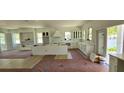 Spacious kitchen with white cabinetry, large center island, and plenty of natural light. Under construction at 1405 50Th N Ave, St Petersburg, FL 33703