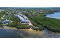 Scenic aerial view of coastal townhomes nestled amidst lush mangroves and waterfront at 1500 Sunset Rd # G4, Tarpon Springs, FL 34689