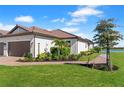 Beautiful single-story home with a well-maintained lawn and landscaping by the lakeside at 15635 Sacile Ln, Bradenton, FL 34211