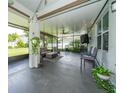 Cozy screened-in patio with ample seating, string lights, and a ceiling fan at 1807 Raven Manor Dr, Dover, FL 33527