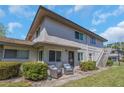 Charming condo with cozy outdoor seating area, clean exterior, and easy stair access to upper units at 1830 Bough Ave # 2, Clearwater, FL 33760