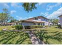 Well-maintained condo building with attractive stone accents and lush landscaping, a welcoming residential community at 1830 Bough Ave # 2, Clearwater, FL 33760