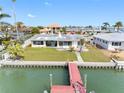 A waterfront property with a wooden dock at 203 Bath Club N Blvd, North Redington Beach, FL 33708