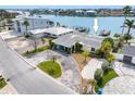 A waterfront home with a driveway and landscaping at 203 Bath Club N Blvd, North Redington Beach, FL 33708