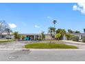 Street view of house with carport and palm trees at 203 Bath Club N Blvd, North Redington Beach, FL 33708