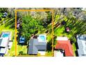 Aerial view of home showcasing property line, screened pool, shed, and surrounding trees at 210 Lake Hobbs Rd, Lutz, FL 33548