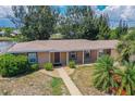 Tan house with walkway and well-manicured lawn at 21838 Edgewater Dr, Port Charlotte, FL 33952