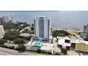 Aerial view of high-rise condominium with water views, featuring a rooftop amenity deck, and surrounding buildings at 2910 W Barcelona St # 403, Tampa, FL 33629