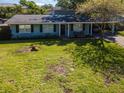 Inviting home showcasing a well-maintained lawn and appealing curb appeal at 3316 S Shamrock Rd, Tampa, FL 33629