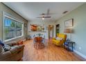 Bright living room showing open floor plan with hardwood floors, dining area, and comfortable seating arrangements at 3504 N 12Th St, Tampa, FL 33605