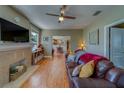 Inviting living room featuring hardwood floors, a decorative fireplace, and large windows providing natural light at 3504 N 12Th St, Tampa, FL 33605