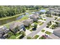 An aerial view showcases homes near a serene pond and lush green landscaping at 35965 Saddle Palm Way, Zephyrhills, FL 33541