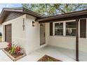 A welcoming front entrance with a freshly painted door, modern light fixture and well maintained landscaping at 3707 14Th Se Ave, Largo, FL 33771