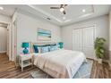 Cozy main bedroom featuring a tray ceiling, closet, and charming decor at 4559 Mitcher Rd, New Port Richey, FL 34652