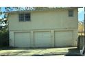 This exterior view shows a multi-car garage, attached to the main house at 4628 Cypress S Way, St Petersburg, FL 33705
