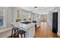 Modern kitchen with white cabinets, stainless steel appliances, and a large island at 5912 N Lynn Ave, Tampa, FL 33604
