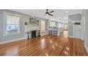 Bright living room featuring a decorative fireplace, hardwood floors, and large windows at 5912 N Lynn Ave, Tampa, FL 33604