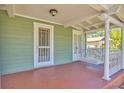 Inviting porch with a swing, columns, and a door, offering a relaxing outdoor space at 5912 N Lynn Ave, Tampa, FL 33604