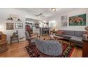 Cozy living room featuring hardwood floors, stylish furniture, and an open floor plan to the kitchen at 604 W Hilda St, Tampa, FL 33603