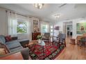 Bright living room with hardwood floors, stylish decor, and a cozy seating area at 604 W Hilda St, Tampa, FL 33603