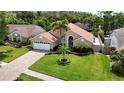 Charming single-story home with a well-manicured lawn, lush landscaping, and inviting curb appeal at 6716 Frontier Ln, Tampa, FL 33625